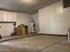 Spacious garage with white cabinets and water heater at 4007 W Rue De Lamour Ave, Phoenix, AZ 85029