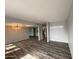 Open living space featuring wood floors and modern light fixture at 4007 W Rue De Lamour Ave, Phoenix, AZ 85029