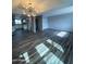 Open floor plan with wood floors and a view into the kitchen at 4007 W Rue De Lamour Ave, Phoenix, AZ 85029