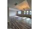 Bright living room features wood floors and modern light fixture at 4007 W Rue De Lamour Ave, Phoenix, AZ 85029
