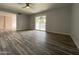 Bright living room with wood floors and sliding glass doors at 4007 W Rue De Lamour Ave, Phoenix, AZ 85029