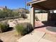 View of the backyard featuring desert landscaping, a covered patio, and a perimeter wall at 4335 E Monte Way, Phoenix, AZ 85044