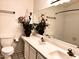 Bathroom with a dual sink vanity, a large mirror, and decorative accents at 4335 E Monte Way, Phoenix, AZ 85044