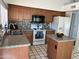 Kitchen with granite countertops, mosaic backsplash, and a white refrigerator and range at 4335 E Monte Way, Phoenix, AZ 85044