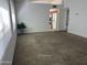 A spacious, naturally lit living room with neutral carpet and an open view into the kitchen at 4335 E Monte Way, Phoenix, AZ 85044