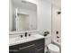 Updated bathroom with black fixtures, vanity with framed mirror and a tub shower combination at 455 E Garfield St, Tempe, AZ 85288