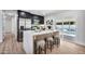 Updated kitchen featuring a modern island with seating, stainless steel appliances, and direct access to the pool at 455 E Garfield St, Tempe, AZ 85288