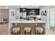 Modern kitchen boasts a spacious island with seating, sleek appliances, and stylish cabinetry at 455 E Garfield St, Tempe, AZ 85288