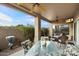 Outdoor patio area with glass top table and chairs, ceiling fan, and comfortable wicker seating at 4744 E Casey Ln, Cave Creek, AZ 85331