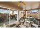 Spacious covered patio featuring wicker furniture, an outdoor dining area, and sliding glass doors to the home at 4744 E Casey Ln, Cave Creek, AZ 85331