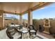 Relaxing covered patio with comfortable wicker seating, ceiling fan, and decorative water feature at 4744 E Casey Ln, Cave Creek, AZ 85331
