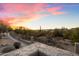 Picturesque desert view from a backyard featuring desert plants and distant houses under a vibrant sky at 4744 E Casey Ln, Cave Creek, AZ 85331