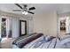 Cozy bedroom with ceiling fan, sliding glass doors, and ensuite bathroom at 4828 E Capistrano Ave, Phoenix, AZ 85044