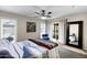 Bright bedroom featuring a ceiling fan, a large window, and sliding glass doors, providing ample natural light and a pleasant view at 4828 E Capistrano Ave, Phoenix, AZ 85044