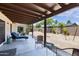 The covered patio provides an outdoor lounge area with a view to the backyard at 4828 E Capistrano Ave, Phoenix, AZ 85044