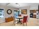 Dining area with a round table, sliding glass doors, and a view of the kitchen at 4828 E Capistrano Ave, Phoenix, AZ 85044