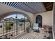 Enclosed front porch, archway entry, covered seating area with a view of the neighborhood at 4828 E Capistrano Ave, Phoenix, AZ 85044