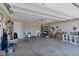 The garage features high ceilings, storage shelving, and plenty of open space at 4828 E Capistrano Ave, Phoenix, AZ 85044
