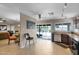 Open kitchen area with stainless steel appliances, tile floors, backyard access, and adjacent dining and living areas at 4828 E Capistrano Ave, Phoenix, AZ 85044