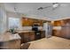 Bright kitchen with stainless steel appliances, brown cabinets, and tile floors at 4828 E Capistrano Ave, Phoenix, AZ 85044