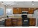 Bright kitchen featuring wooden cabinets, granite countertops, and modern appliances, offering style and functionality at 4828 E Capistrano Ave, Phoenix, AZ 85044