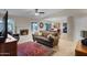 Bright living room with tile flooring, fireplace, and a view of dining area at 4828 E Capistrano Ave, Phoenix, AZ 85044