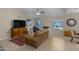 Open-concept living room with a fireplace, ceiling fan, and view of the dining area at 4828 E Capistrano Ave, Phoenix, AZ 85044