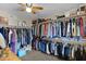Spacious walk-in closet with ample hanging space and shelving, providing organized storage for clothing and accessories at 4828 E Capistrano Ave, Phoenix, AZ 85044