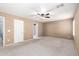 Large bedroom featuring a ceiling fan, carpet flooring, and an ensuite bathroom at 494 W Midland Ln, Gilbert, AZ 85233