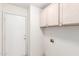 Laundry room with ample storage cabinets and door to outside at 494 W Midland Ln, Gilbert, AZ 85233