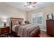 Cozy bedroom with a bed, side table, and window with plantation shutters at 5335 E Shea Blvd # 2102, Scottsdale, AZ 85254