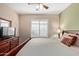 This bedroom has a bed with a ceiling fan and plantation shutters at 5335 E Shea Blvd # 2102, Scottsdale, AZ 85254