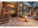 Charming condo exterior featuring a well-lit walkway and inviting staircase to upper units at 5335 E Shea Blvd # 2102, Scottsdale, AZ 85254