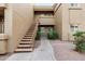 Exterior of a tan condo building featuring an exterior staircase and surrounding landscape at 5335 E Shea Blvd # 2102, Scottsdale, AZ 85254