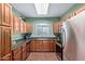 Bright kitchen featuring wood cabinets, granite countertops, a sink, and stainless steel refrigerator at 5335 E Shea Blvd # 2102, Scottsdale, AZ 85254