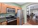 The kitchen features stainless steel appliances, including a range, microwave, and refrigerator at 5335 E Shea Blvd # 2102, Scottsdale, AZ 85254