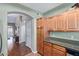 Kitchen featuring wooden cabinets, granite counters, stainless steel appliances, and an archway to the living room at 5335 E Shea Blvd # 2102, Scottsdale, AZ 85254