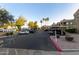 A parking lot surrounded by palm trees and well-maintained landscaping near a residential building at 5335 E Shea Blvd # 2102, Scottsdale, AZ 85254