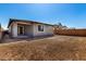 View of the backyard with a covered patio and unlandscaped yard surrounded by a block wall at 5358 W Las Palmaritas Dr, Glendale, AZ 85302