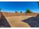 Unlandscaped backyard with block wall offering potential for a custom outdoor oasis at 5358 W Las Palmaritas Dr, Glendale, AZ 85302