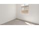 Bright and empty bedroom with neutral carpet and a window at 5358 W Las Palmaritas Dr, Glendale, AZ 85302
