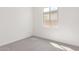 Bright bedroom featuring neutral carpet, fresh paint, and a window for natural light at 5358 W Las Palmaritas Dr, Glendale, AZ 85302