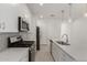 Well-lit kitchen featuring stainless steel appliances, a gray backsplash, white cabinets, and a large island at 5358 W Las Palmaritas Dr, Glendale, AZ 85302