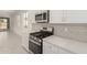 Modern kitchen featuring stainless steel appliances, quartz countertops and white cabinets with subway tile backsplash at 5358 W Las Palmaritas Dr, Glendale, AZ 85302