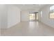 Bright, open living room features light tile flooring and sliding glass doors leading to an outdoor area at 5358 W Las Palmaritas Dr, Glendale, AZ 85302