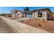 Street view of a new build featuring desert landscaping, brick driveways, and gray color palette at 5358 W Las Palmaritas Dr, Glendale, AZ 85302