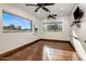 A spacious bedroom with hardwood floors, ceiling fans, and great natural light through large windows at 5508 N Quail Run Rd, Paradise Valley, AZ 85253