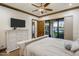 Cozy main bedroom with a comfy bed, a TV, and sliding glass doors leading to the backyard, enhancing indoor-outdoor living at 5508 N Quail Run Rd, Paradise Valley, AZ 85253