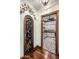 Wine room with custom iron door, adjoining a utility room with cabinetry and ample counter space at 5508 N Quail Run Rd, Paradise Valley, AZ 85253