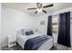 Calm bedroom with blue accents, a ceiling fan, and a window with natural light at 5995 N 78Th St # 1063, Scottsdale, AZ 85250